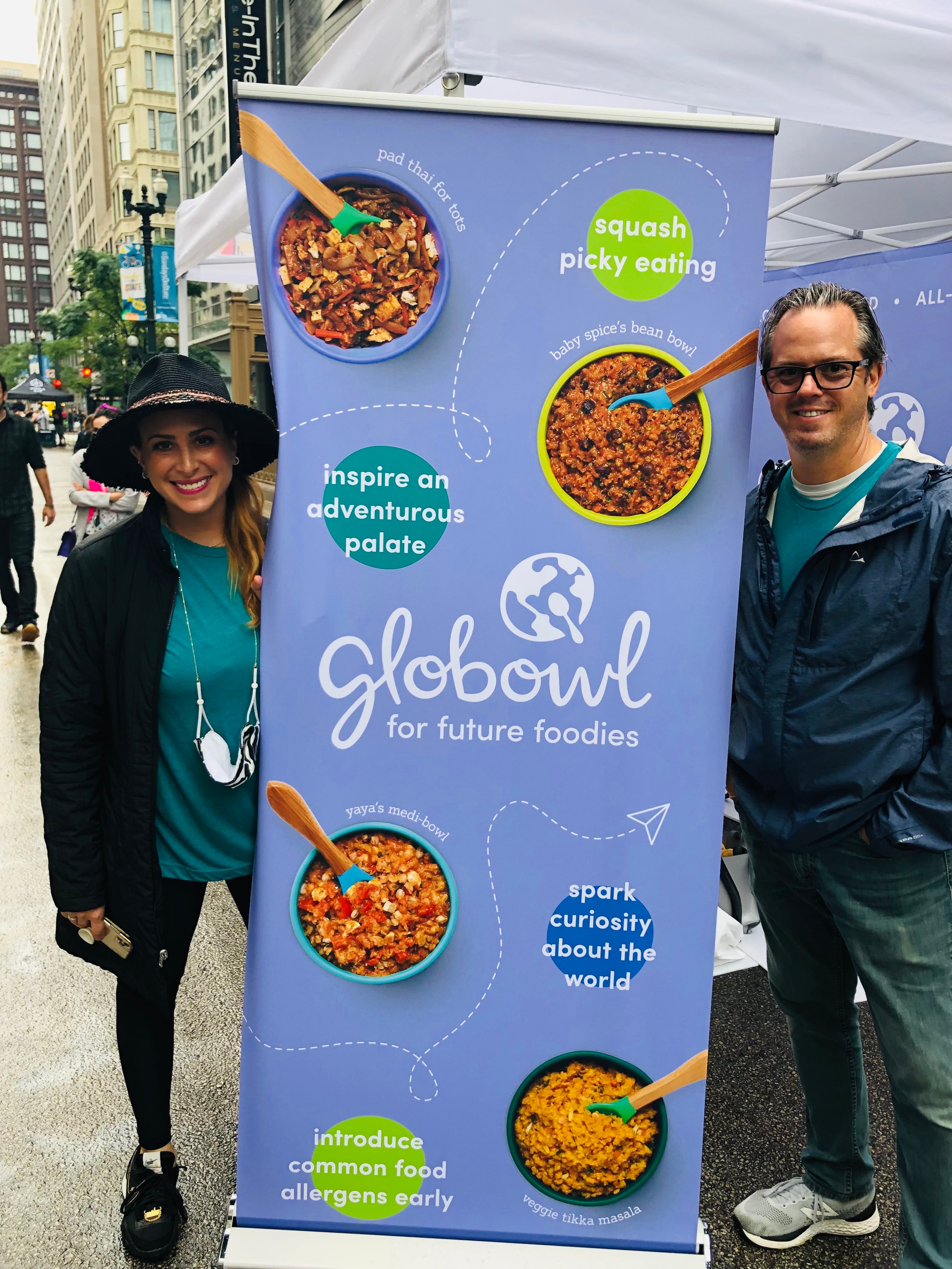 Founder Erica and husband Terry standing on either side of a Globowl brand banner