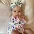 Baby with large black and white boy with fingers in her mouth