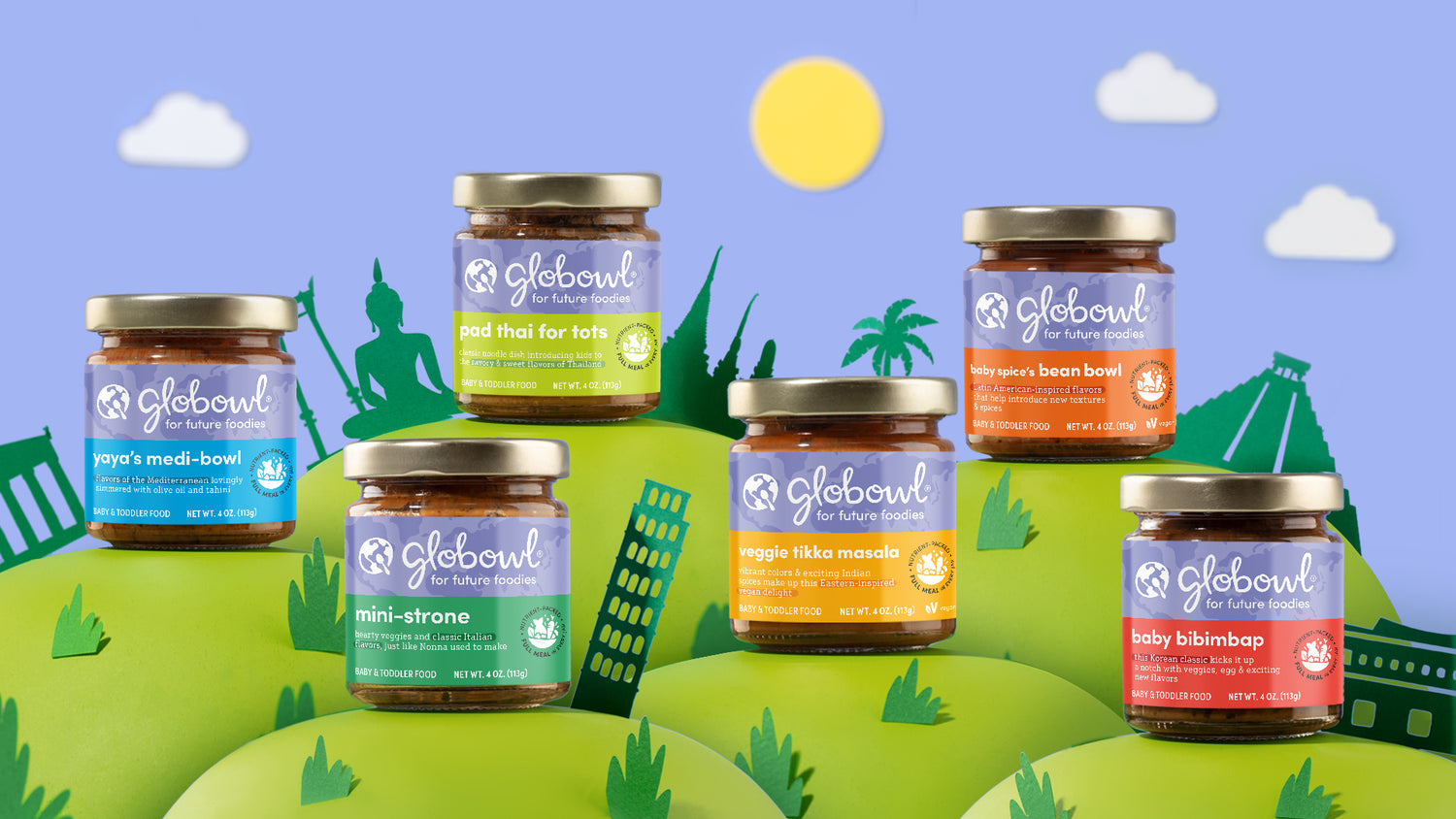 Globowl baby food jars sitting on paper hills with cutout landmarks surrounding each flavor